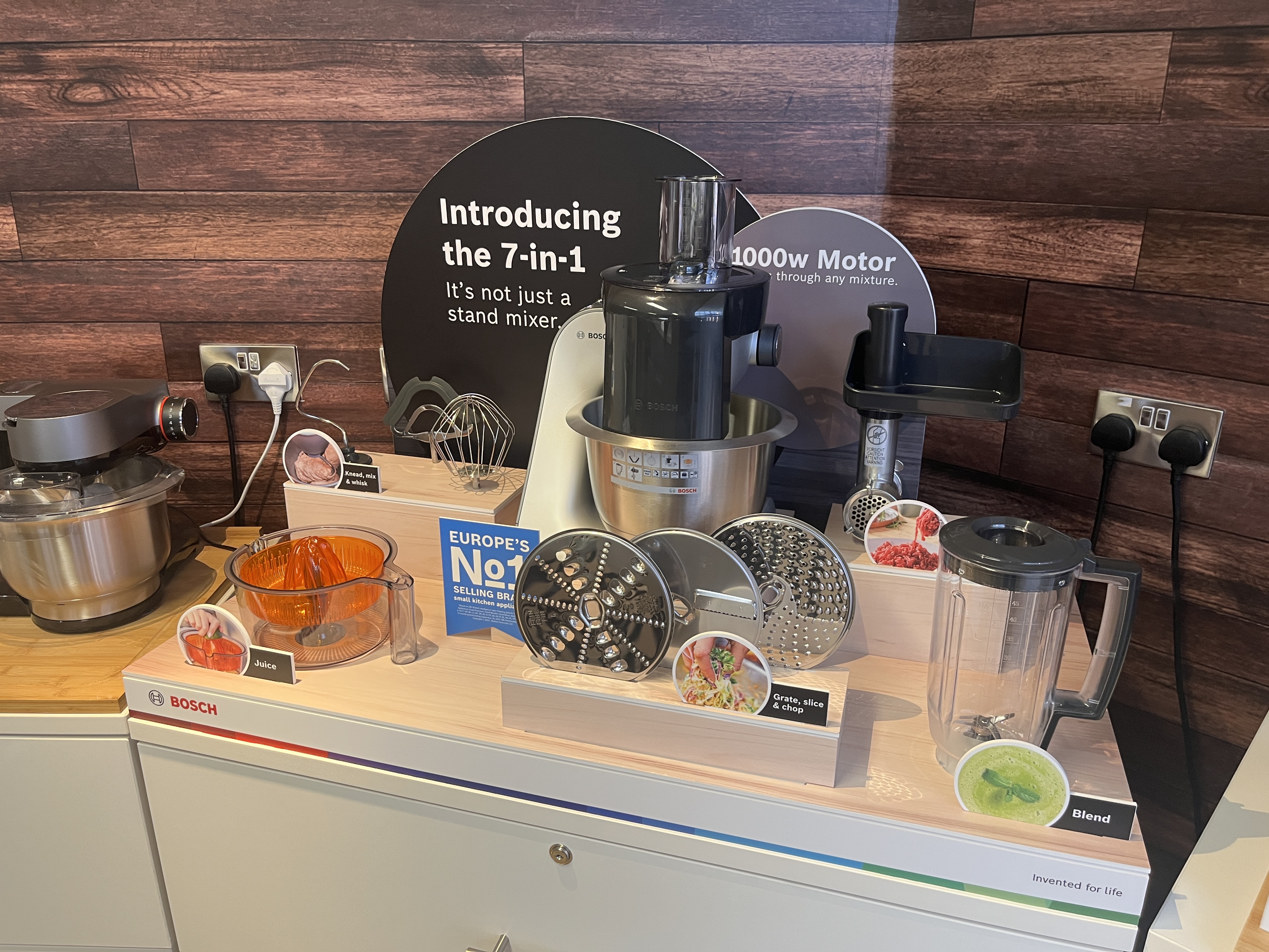 Bosch 7-in-1 stand mixer countertop display unit with attachments and branded signage